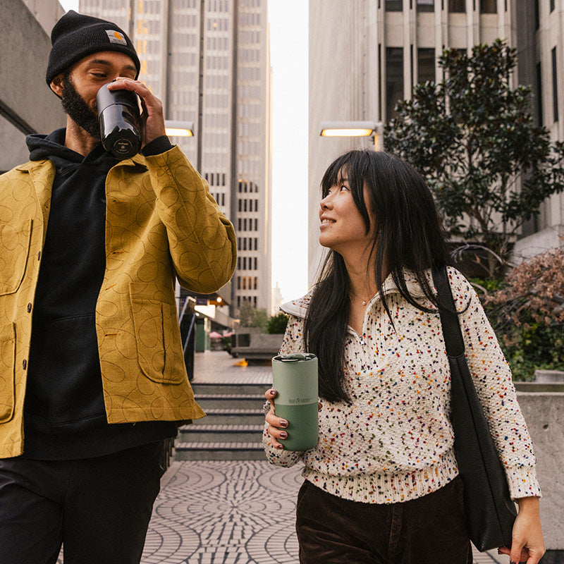 16oz-rise-tumbler-i5 16oz_rise_tumbler_black_iceberg_couple_drink_city_street_square.jpg
