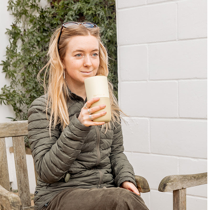 16oz-rise-tumbler-i5 16oz_rise_tumbler_wax_yellow_woman_seat_outside_square.jpg