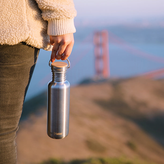 27oz-reflect-with-bamboo-cap-x5 K27SSLRF-BS-BAMBOO_reflect_bottle_bridge_lifestyle.jpg